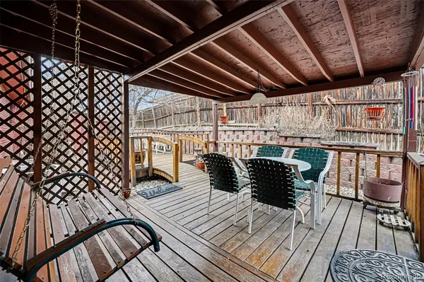 a view of a balcony with wooden floor and outdoor seating