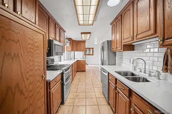 a kitchen with stainless steel appliances granite countertop a sink and cabinets