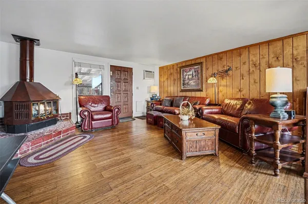 a living room with furniture a rug and a window