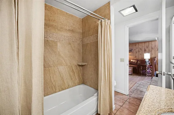 a bathroom with a tub and shower