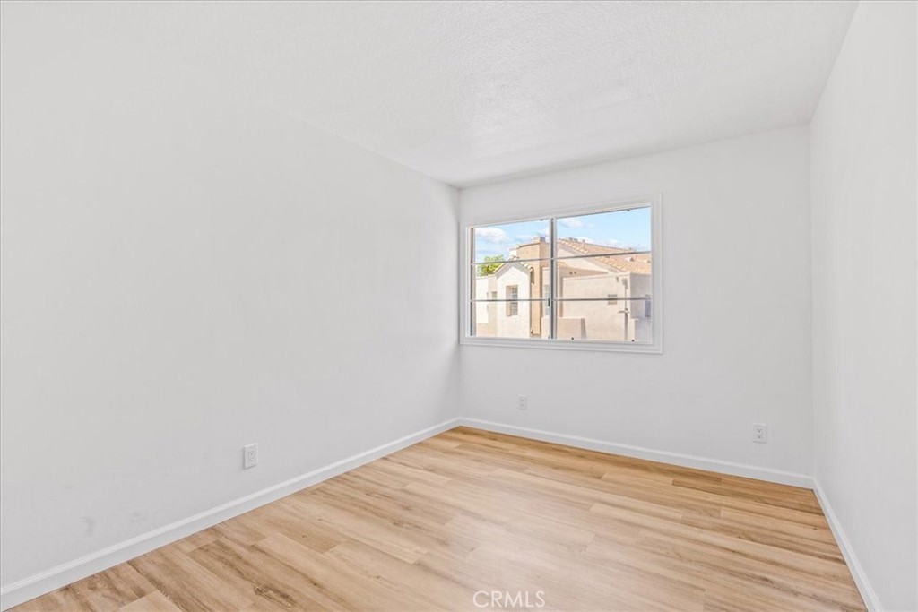 19 Softwind Aliso Viejo, CA 92656 - Photo 14 of 28 an empty room with wooden floor and windows