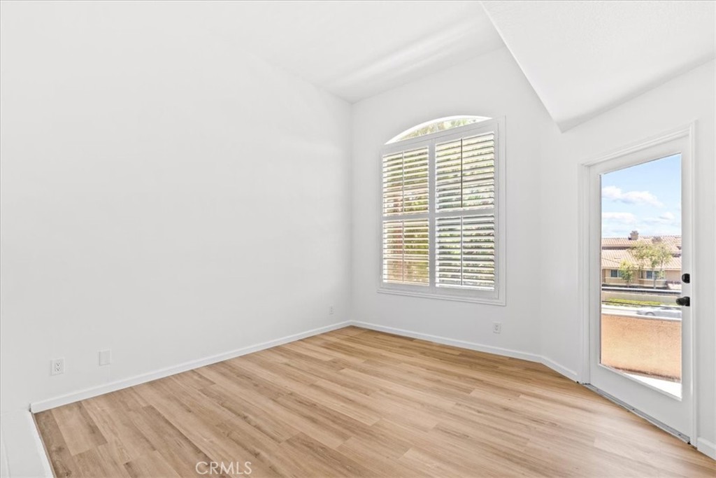 19 Softwind Aliso Viejo, CA 92656 - Photo 18 of 28 an empty room with wooden floor and windows