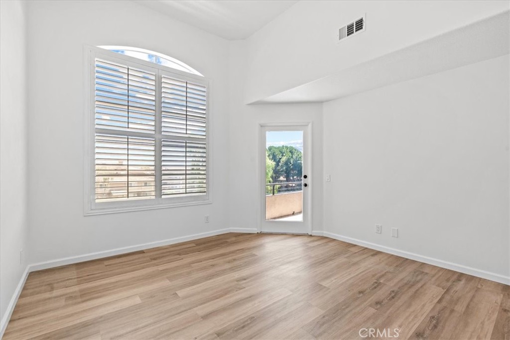 19 Softwind Aliso Viejo, CA 92656 - Photo 21 of 28 an empty room with wooden floor and windows