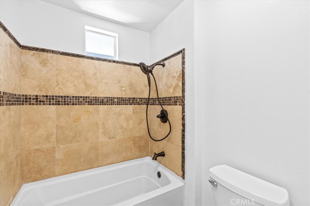 19 Softwind Aliso Viejo, CA 92656 - Photo 22 of 28 a bathroom with a bath tub and a shower
