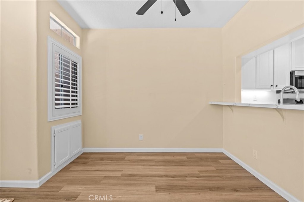 19 Softwind Aliso Viejo, CA 92656 - Photo 4 of 28 a view of kitchen and empty room with wooden floor