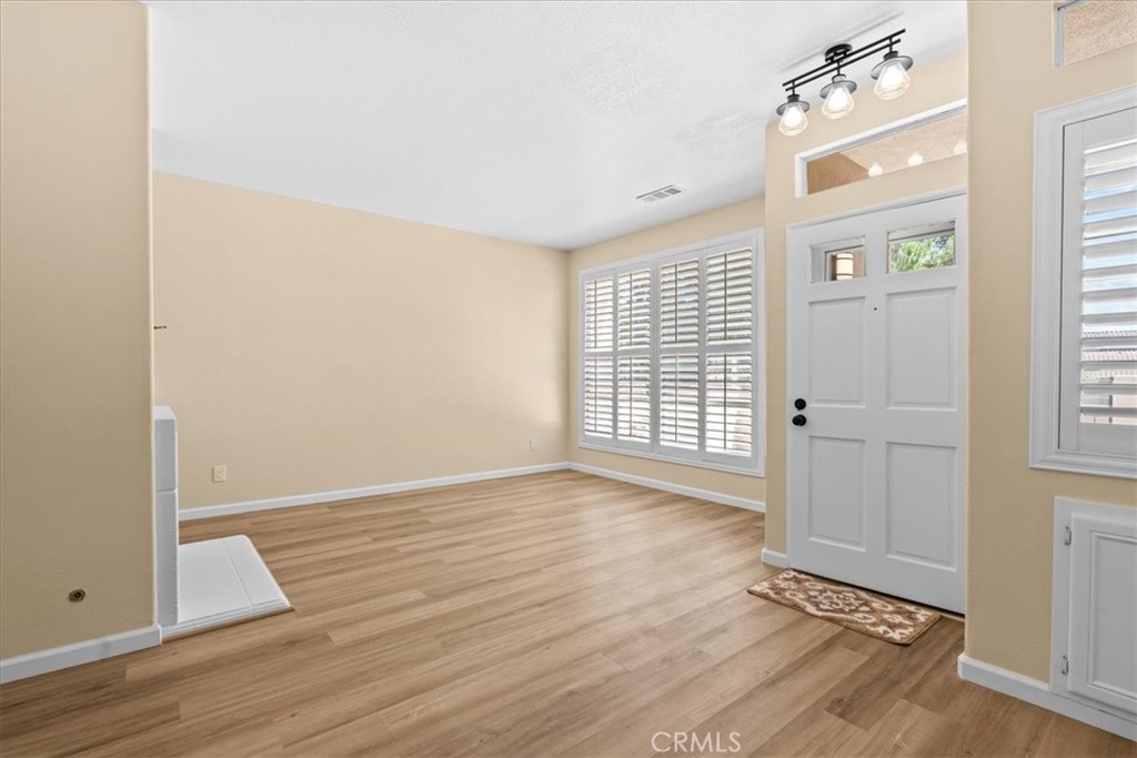 19 Softwind Aliso Viejo, CA 92656 - Photo 5 of 28 an empty room with wooden floor and windows
