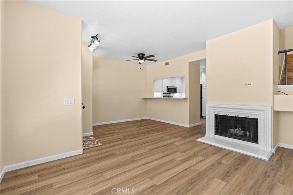 19 Softwind Aliso Viejo, CA 92656 - Photo 6 of 28 a view of empty room with wooden floor and fireplace