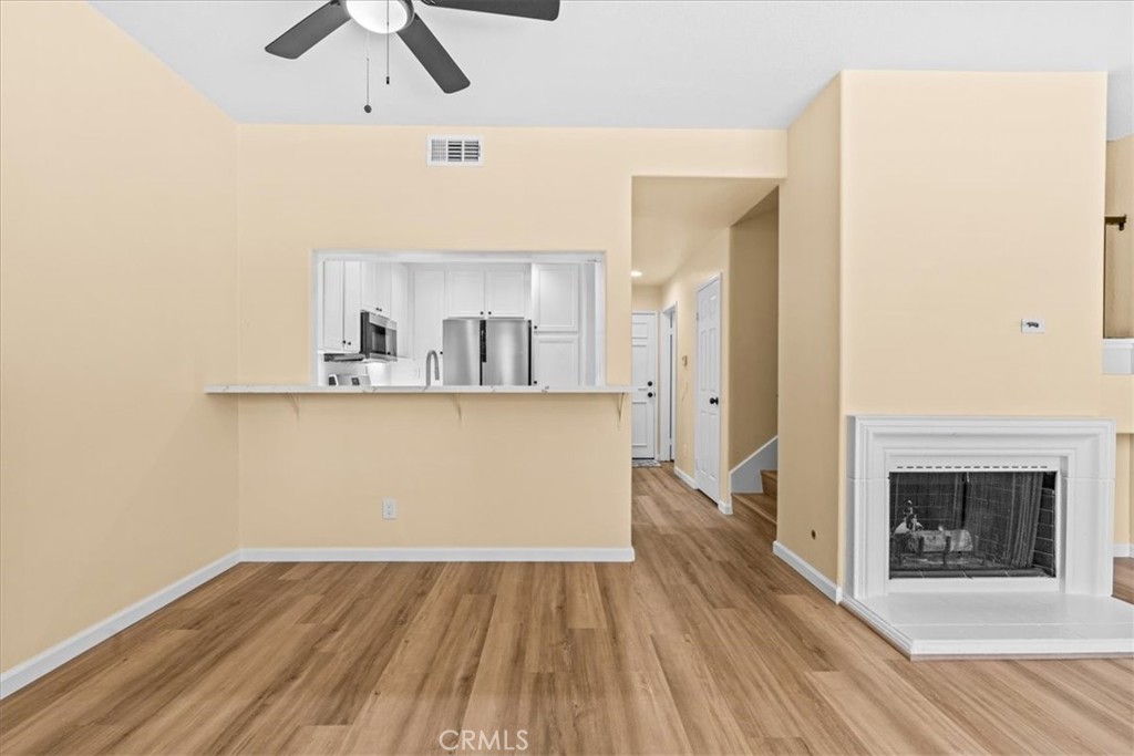 19 Softwind Aliso Viejo, CA 92656 - Photo 7 of 28 a view of a kitchen with wooden floor and a fireplace