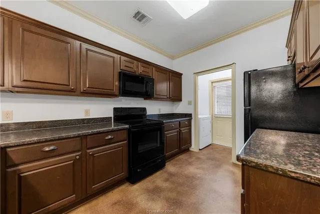 a kitchen with granite countertop a sink and steel appliances