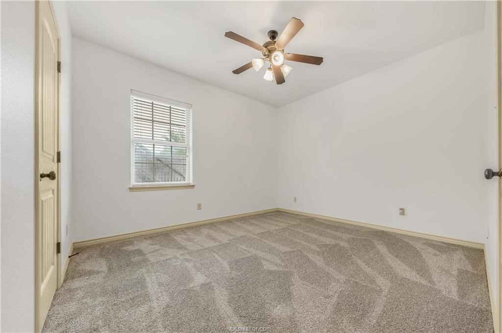 4327 Commando Trail College Station, TX 77845 - Photo 18 of 23 an empty room with windows and ceiling fan