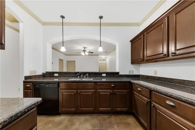 a kitchen with stainless steel appliances granite countertop a sink a stove and a wooden floors