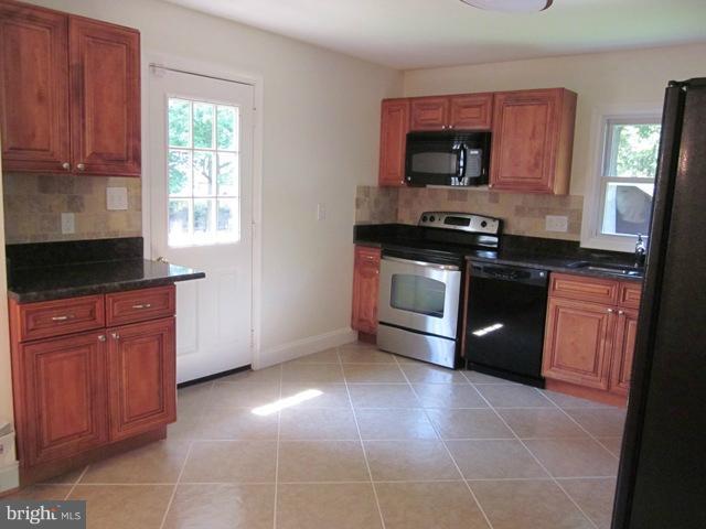 4805 Powder Mill Road Beltsville, MD 20705 - Photo 8 of 24 Tiled Kitchen with stainless Steel Appliances