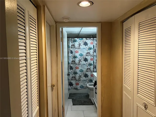a bathroom with a shower and a window