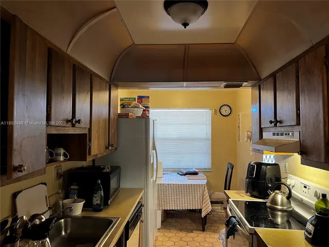 a kitchen with a sink appliances and cabinets