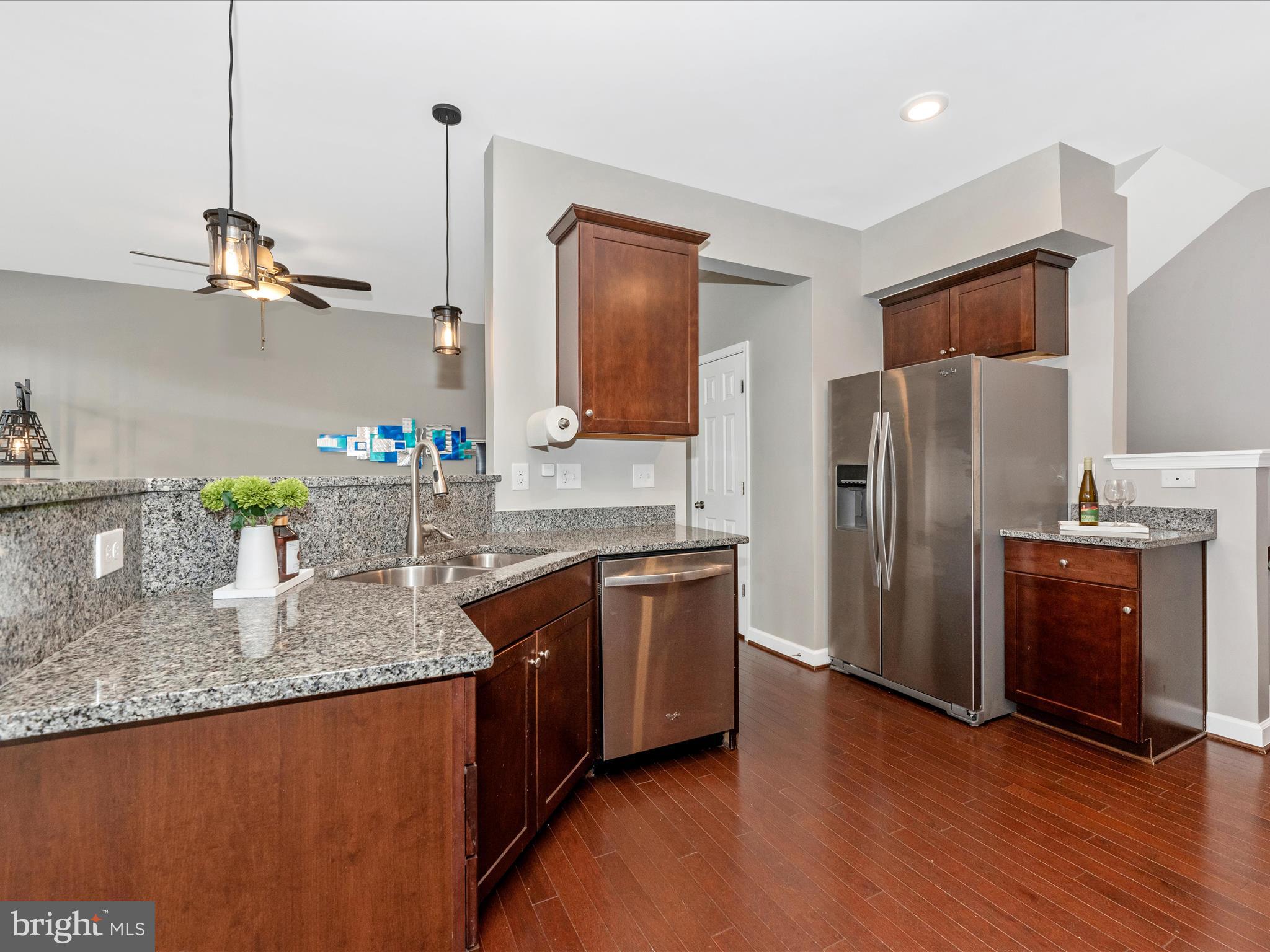 5920 Forum Square Frederick, MD 21703 - Photo 14 of 56 a kitchen with granite countertop kitchen island stainless steel appliances a refrigerator a sink a stove a microwave and wooden floor