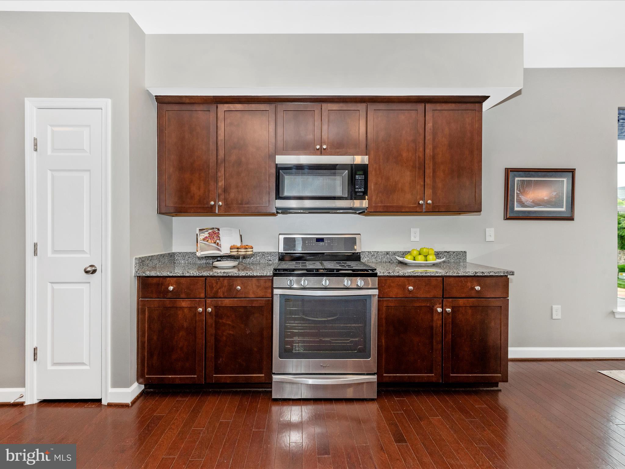 5920 Forum Square Frederick, MD 21703 - Photo 15 of 56 a kitchen with granite countertop wooden cabinets and a stove top oven