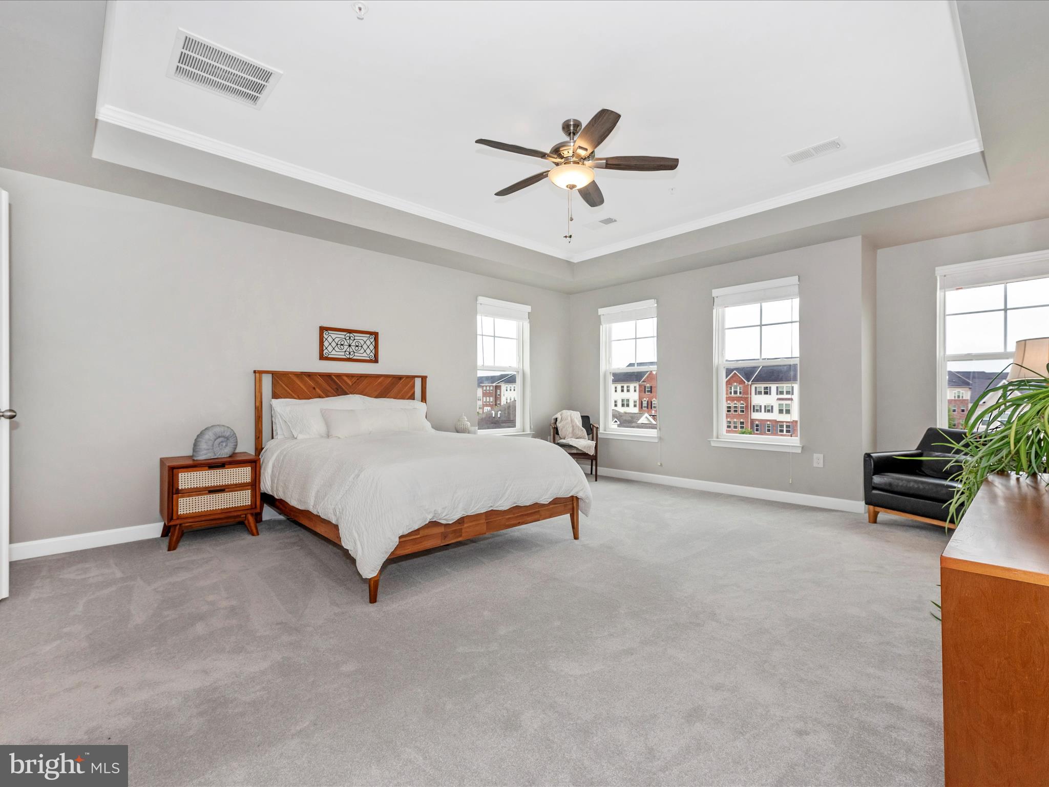 5920 Forum Square Frederick, MD 21703 - Photo 21 of 56 a bedroom with a bed a couch and a chandelier