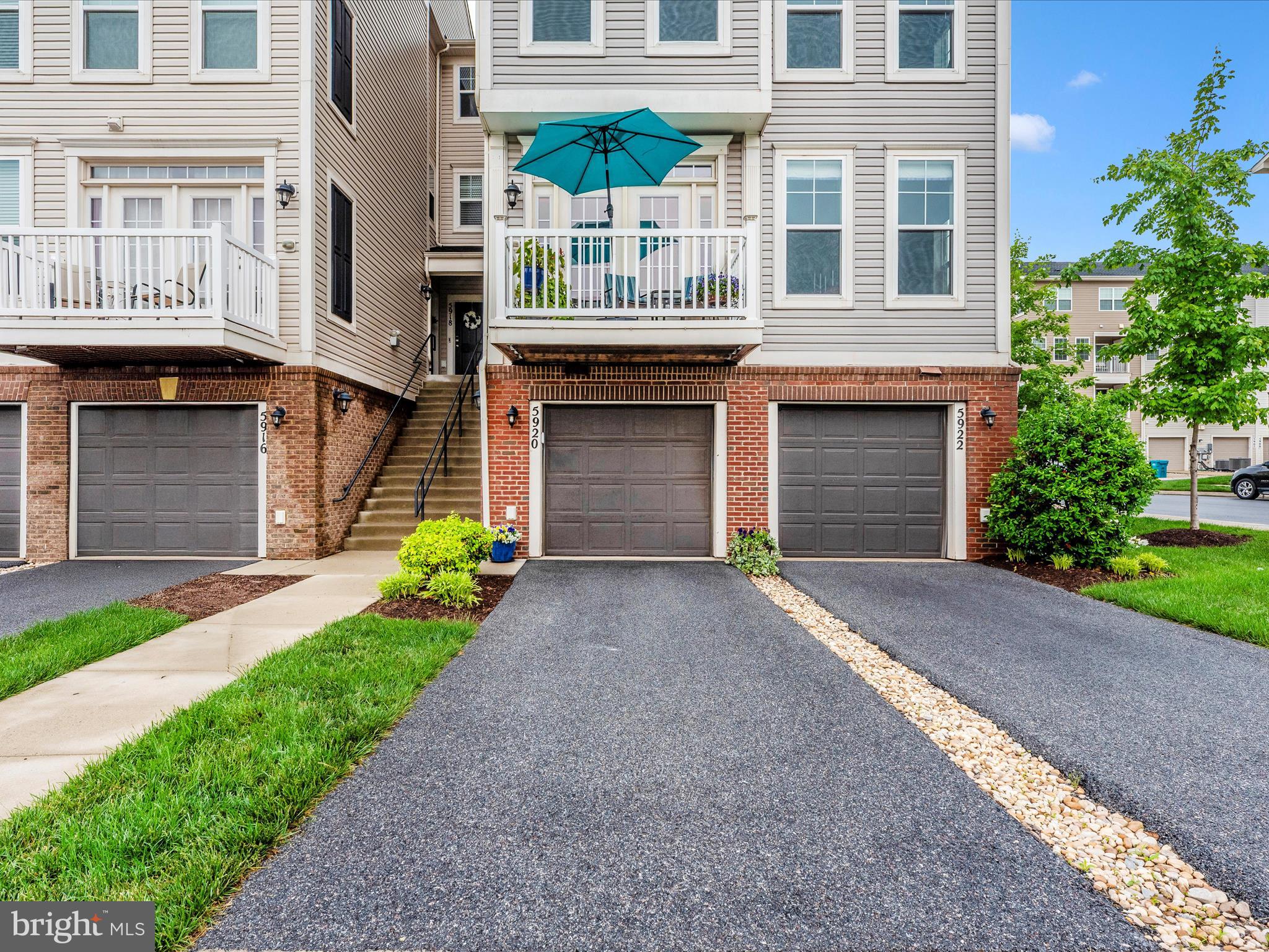 5920 Forum Square Frederick, MD 21703 - Photo 38 of 56 a front view of a building with a garden and plants