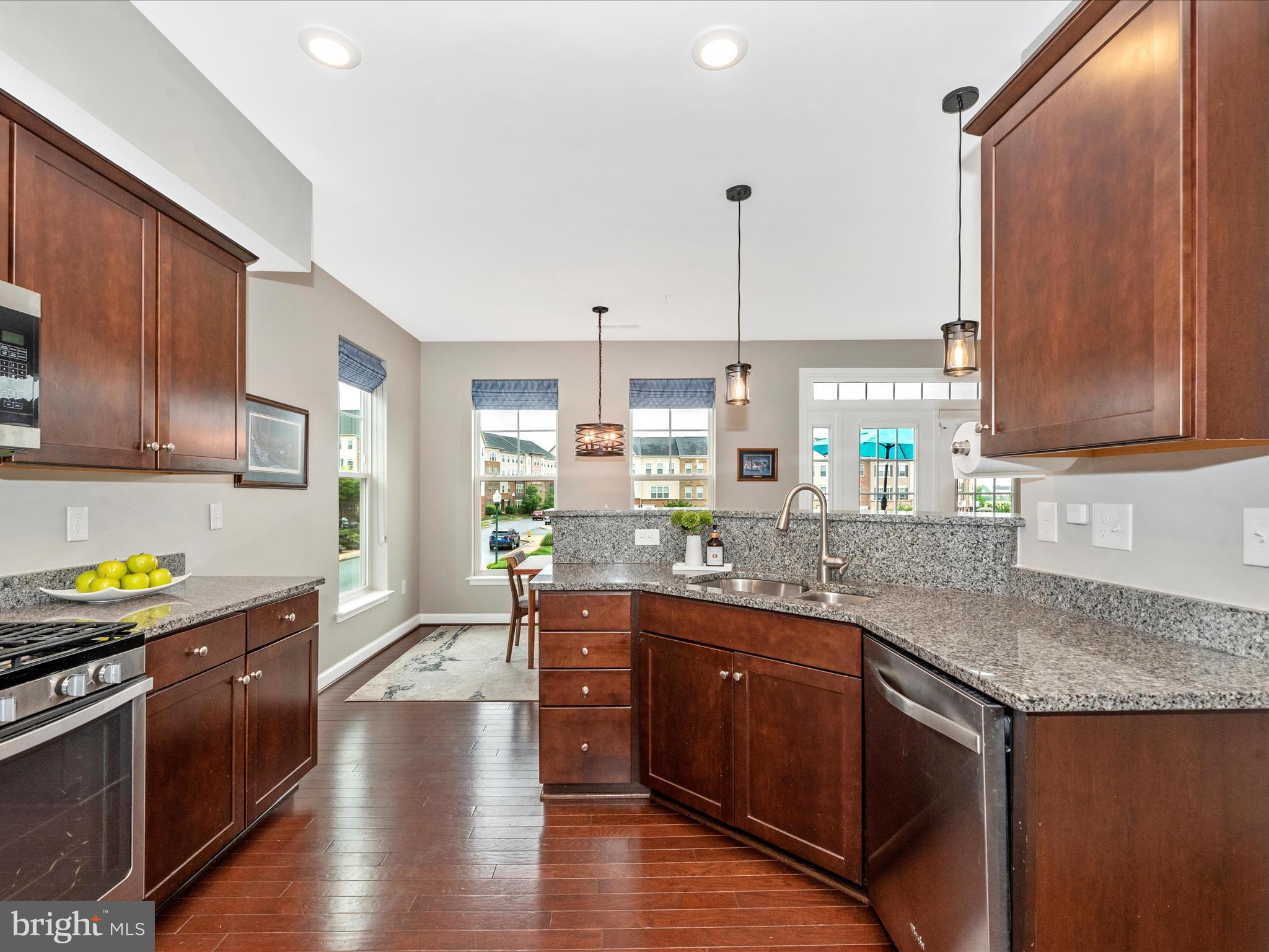 5920 Forum Square Frederick, MD 21703 - Photo 10 of 56 a kitchen with stainless steel appliances granite countertop a stove a sink dishwasher and cabinets with wooden floor