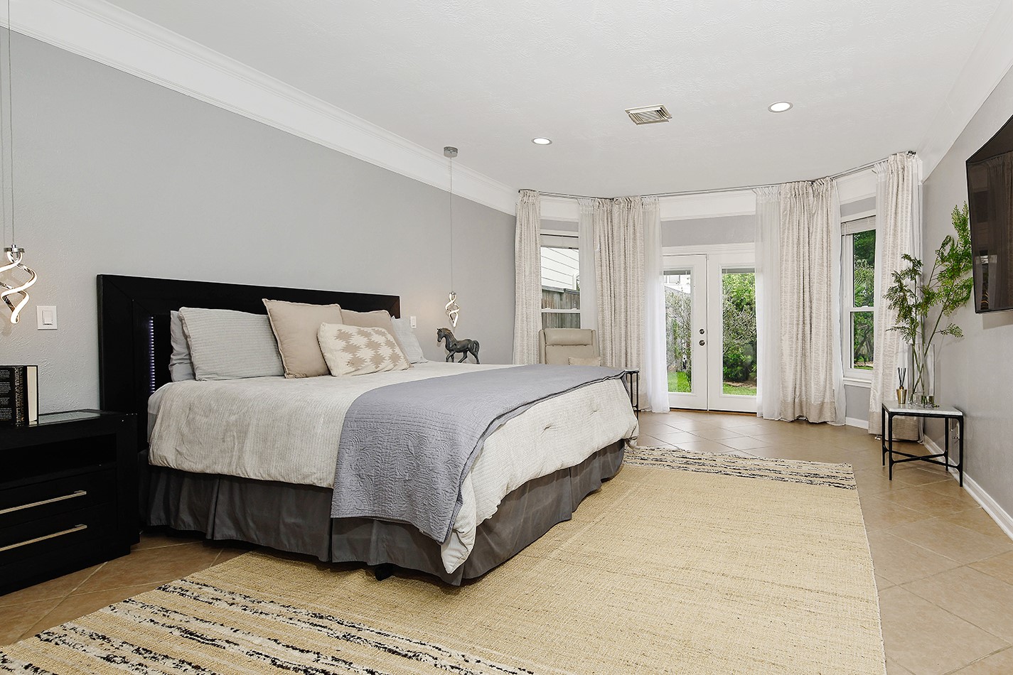 18834 Forest Elms Drive Spring, TX 77388 - Photo 12 of 47 a spacious bedroom with a bed and a couch