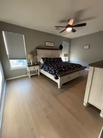 a bedroom with a bed and a ceiling fan