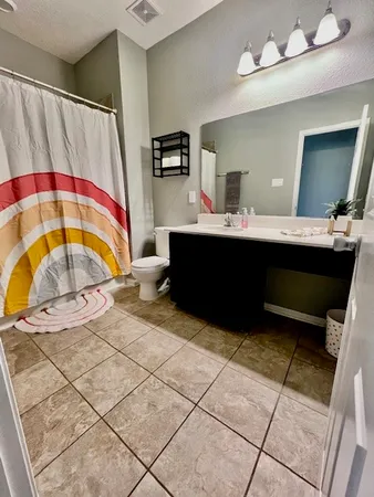 a room with a sink and a mirror