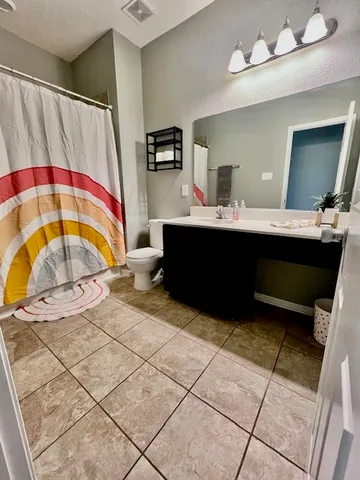 a room with a sink and a mirror