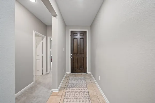 a view of hallway with wooden floor