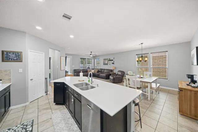 a large white kitchen with a large window