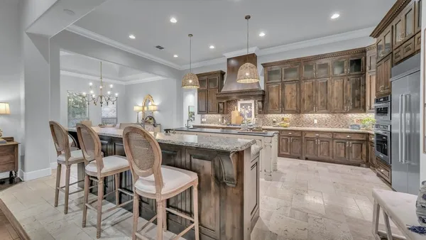 a large kitchen with a table and chairs