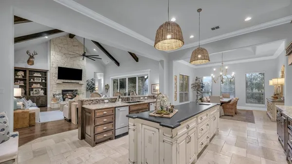 a kitchen with granite countertop a stove sink and cabinets