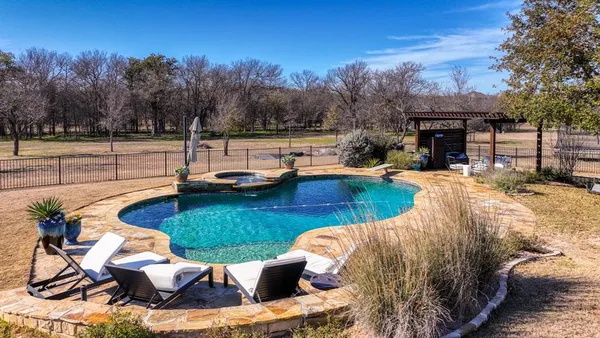 a view of a backyard with sitting area
