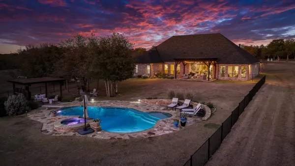 a swimming pool with some trees in the background