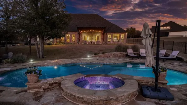 a view of large trees with a backyard