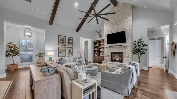 a living room with furniture a fireplace and a flat screen tv