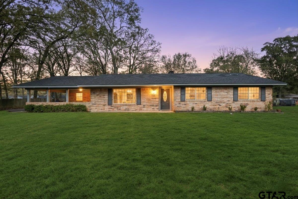 a front view of house with yard and green space