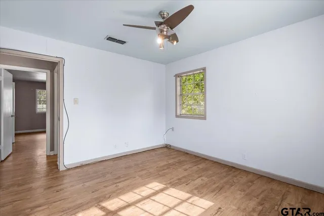 wooden floor in an empty room with a window