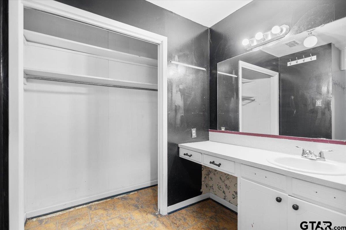 2005 Happy Street Mount Pleasant, TX 75455 - Photo 25 of 41 a bathroom with a sink and a mirror