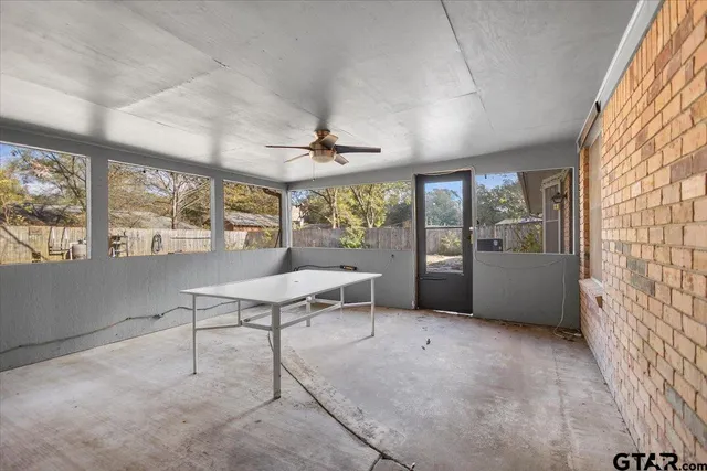 a view of a hallway with a chandelier fan