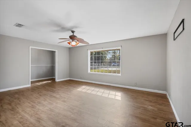 wooden floor in an empty room with a window