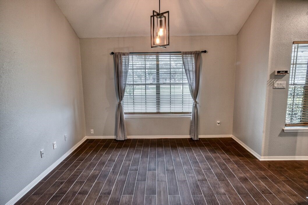 308 County Road 893B Angleton, TX 77515 - Photo 12 of 41 wooden floor in an empty room with a window