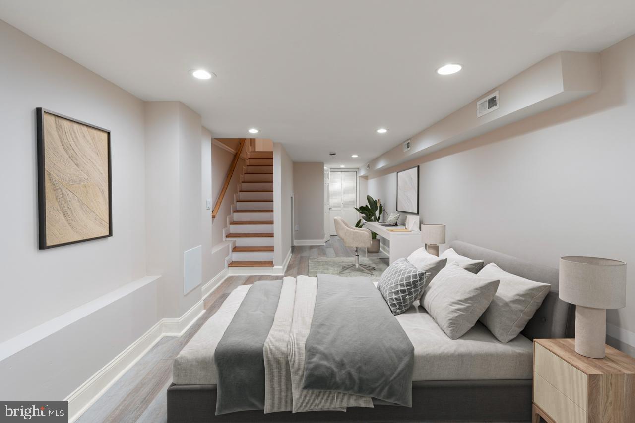 919 Stiles Street Baltimore, MD 21202 - Photo 12 of 36 a bedroom with a bed and a painting