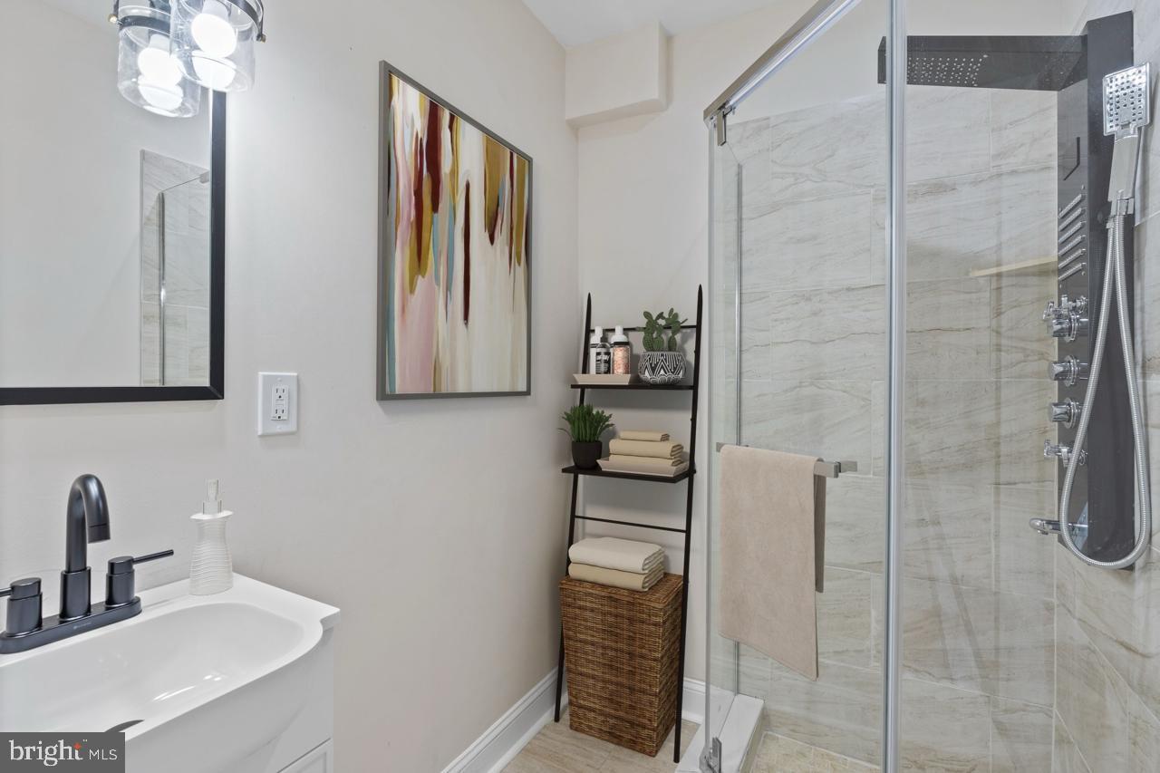 919 Stiles Street Baltimore, MD 21202 - Photo 17 of 36 a bathroom with a sink and mirror