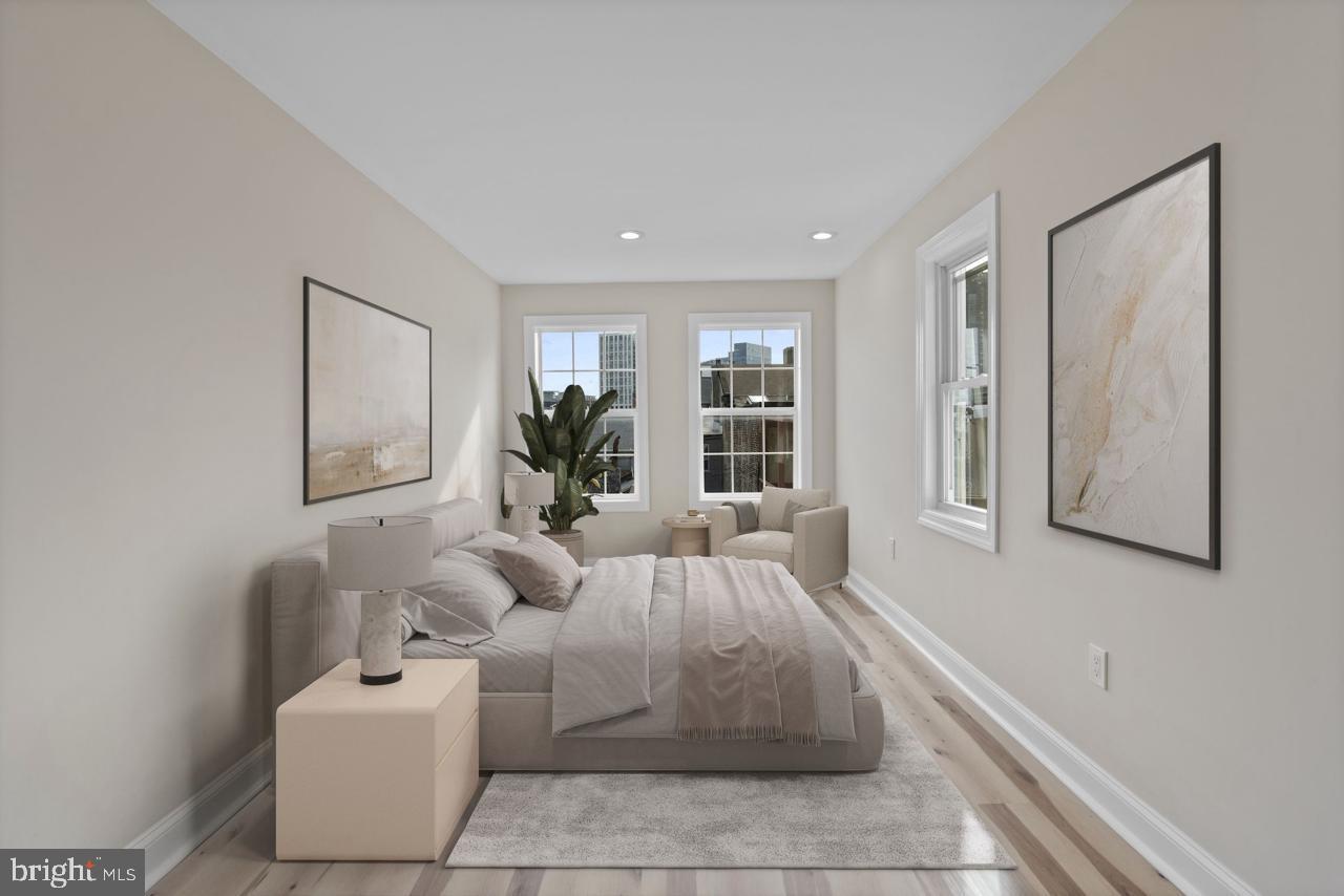 919 Stiles Street Baltimore, MD 21202 - Photo 17 of 36 a bedroom with furniture and a large window