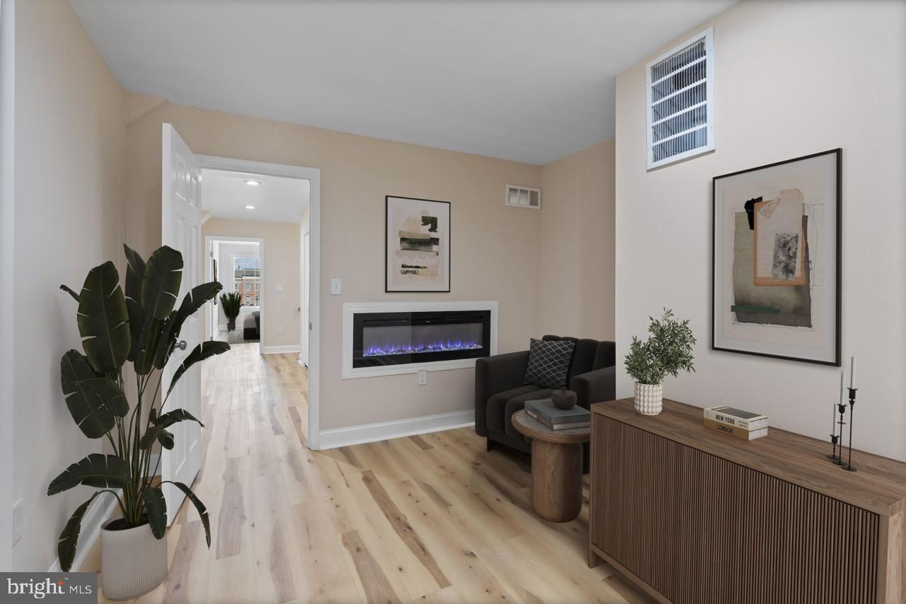 919 Stiles Street Baltimore, MD 21202 - Photo 19 of 36 a living room with furniture and a fireplace