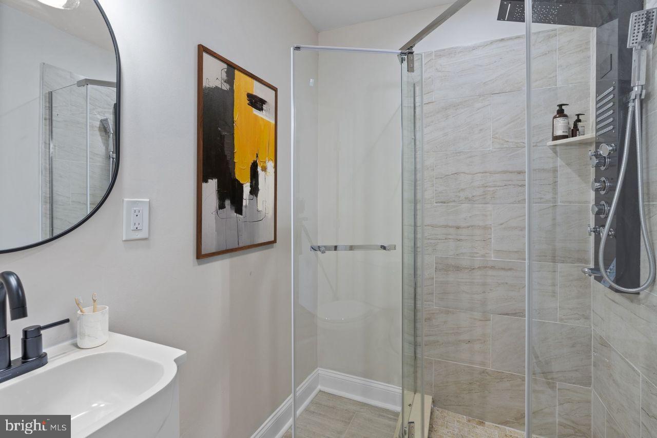 919 Stiles Street Baltimore, MD 21202 - Photo 22 of 36 a bathroom with a sink and a mirror