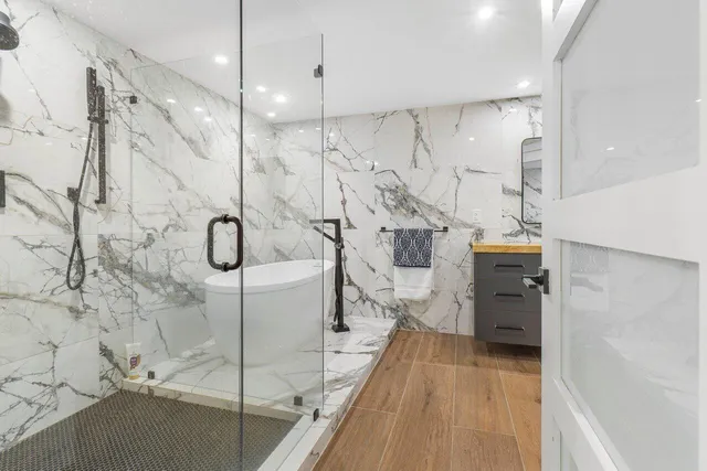 a bathroom with a bathtub and a shower