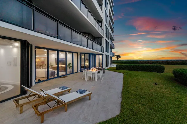 a view of backyard with swimming pool and seating