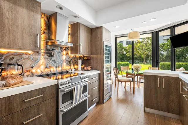 a kitchen with stainless steel appliances granite countertop a stove and wooden cabinets