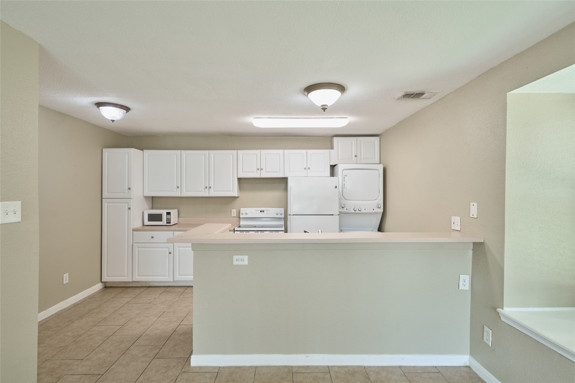 16120 Stuebner Airline Road, Unit 212 Spring, TX 77379 - Photo 11 of 29 a kitchen with stainless steel appliances a refrigerator sink and white cabinets